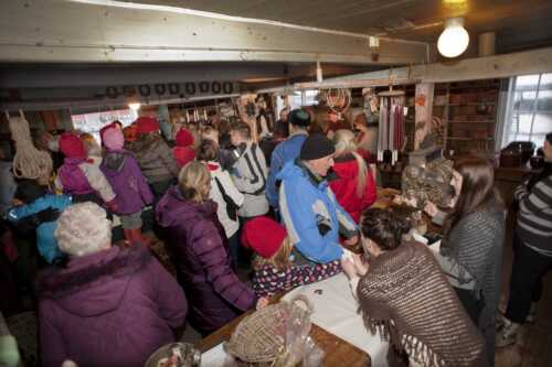 Many people crammed into a small shop