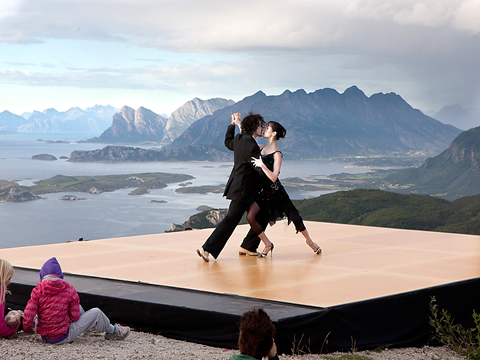Two persons dancing on a mountain